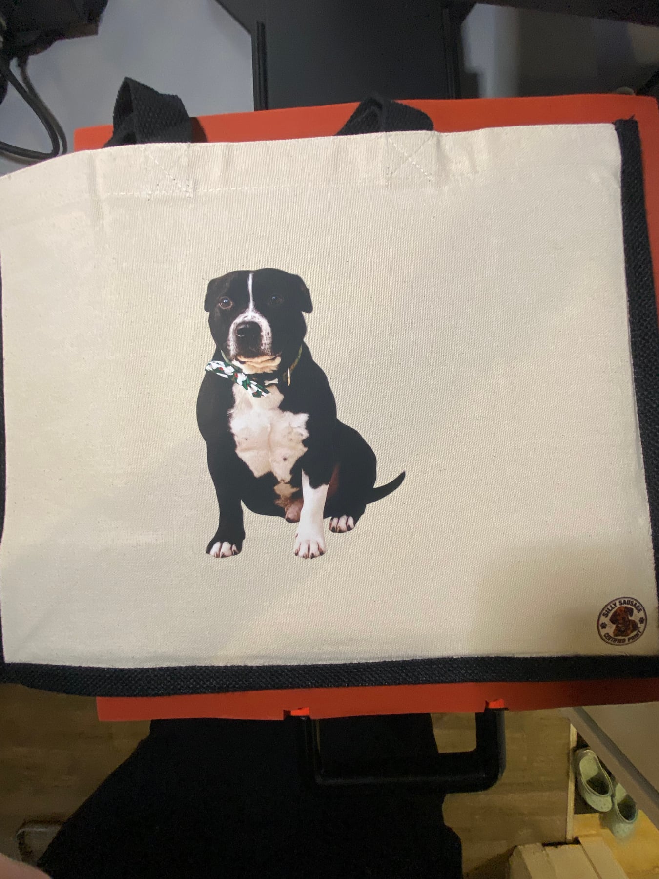 Finished black-trim personalised tote printed with a black and white dog