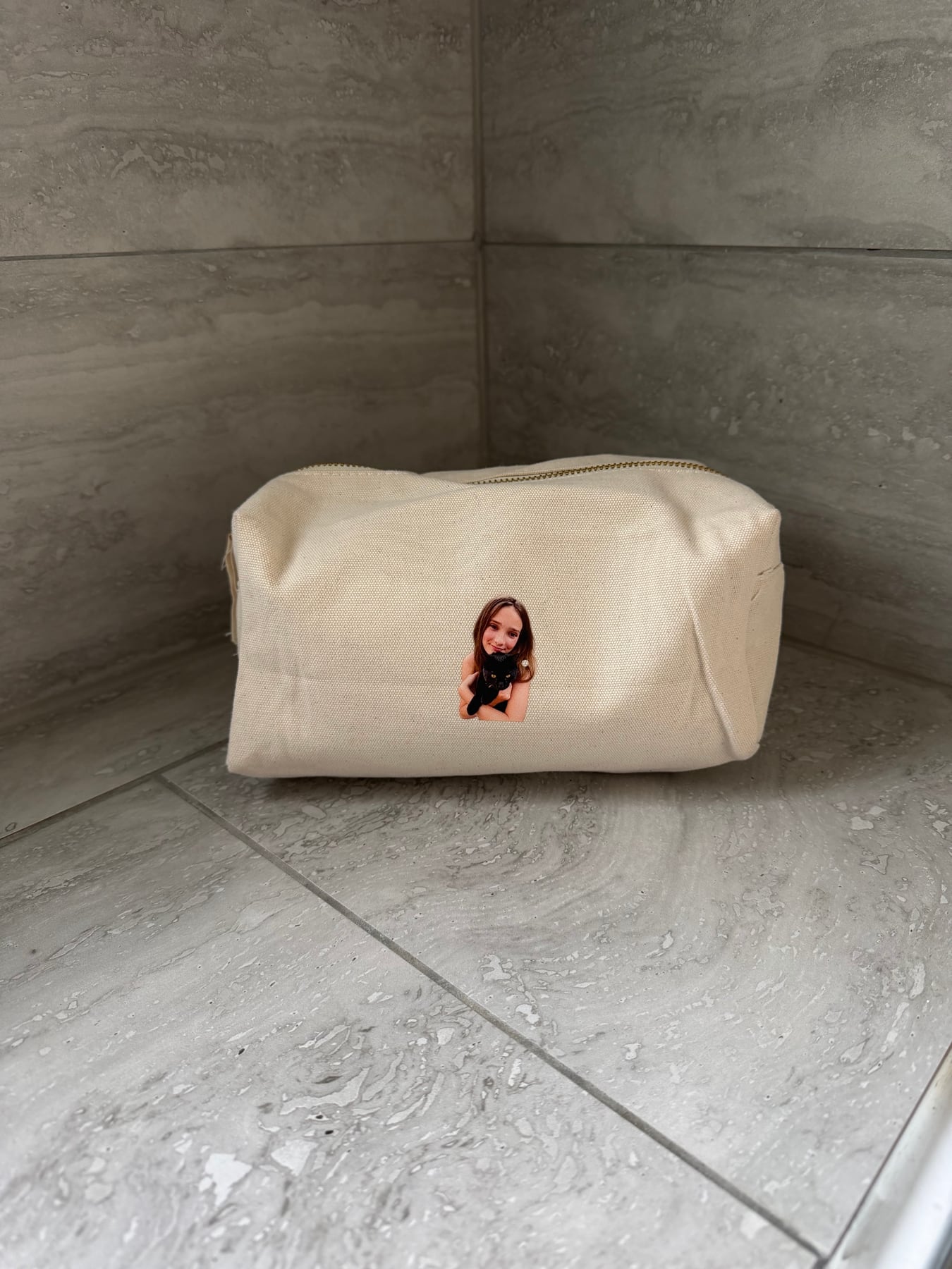 Cream personalised pouch printed with a child holding a black pet