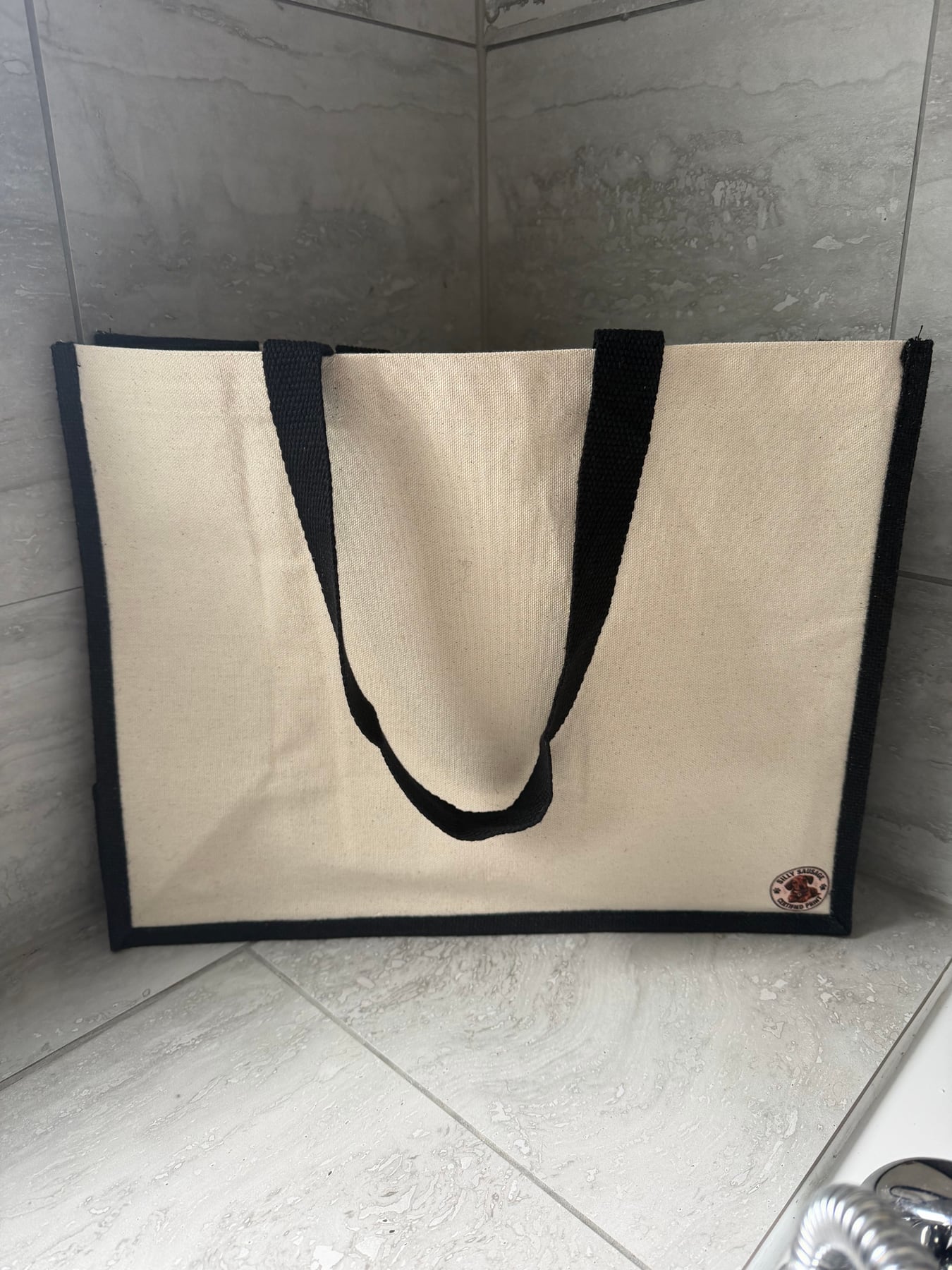 Reverse of the two-pet shopper with black handles and a Silly Sausage badge
